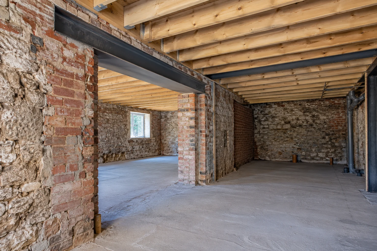 Illustrative brick basement structural preparation with a supported steel beam