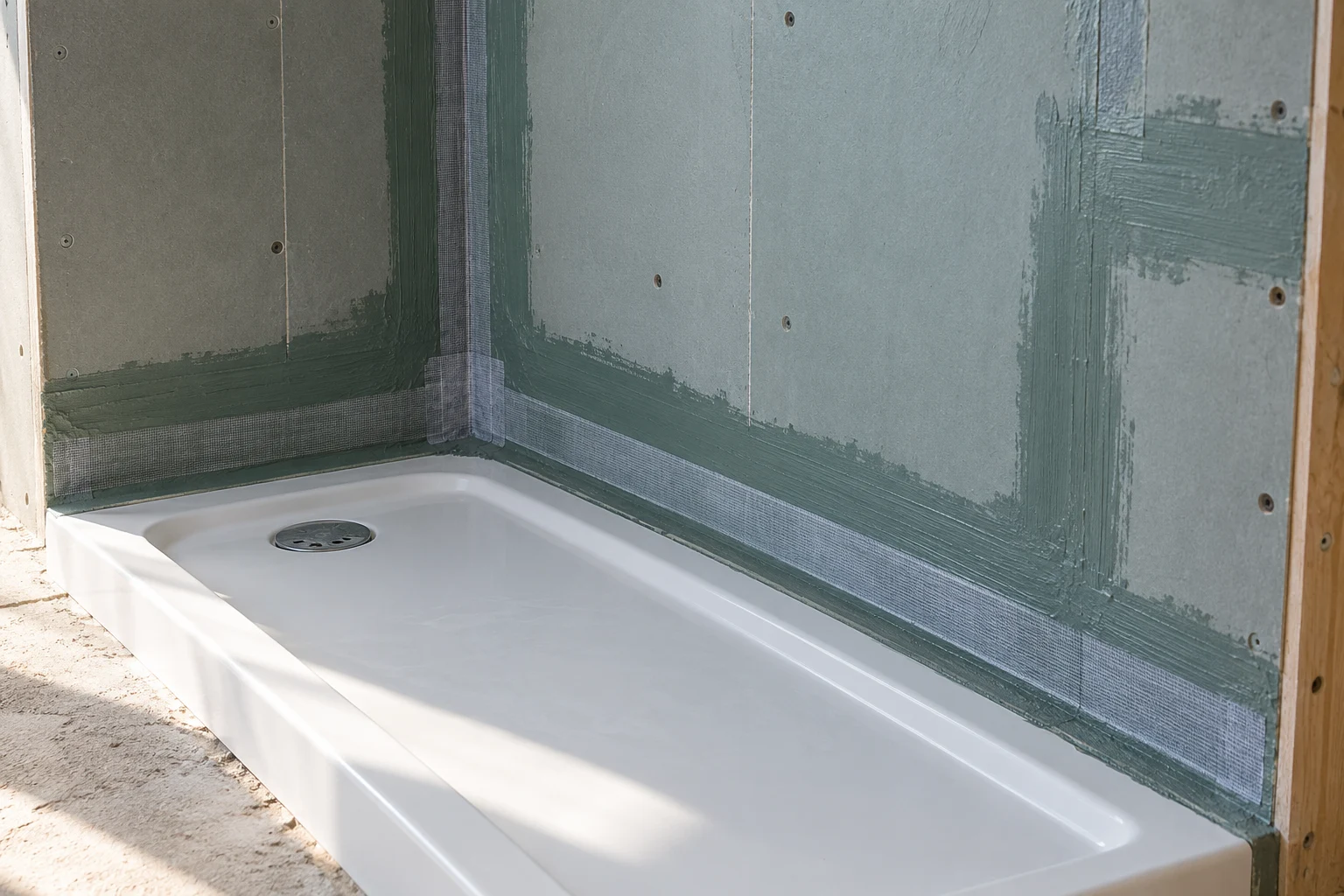 Illustrative waterproof coating and sealed shower tray junction before tiling
