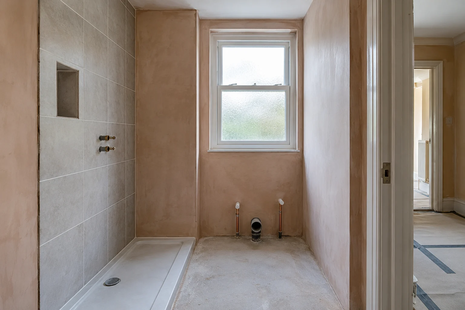 Illustrative prepared bathroom surfaces and capped connections before finishes